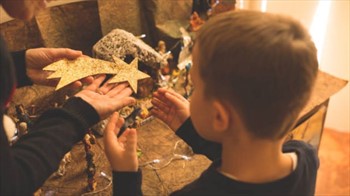 Detalle de un niño montando el Belén