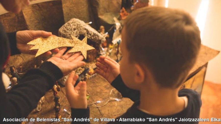 Detalle de un niño montando el Belén